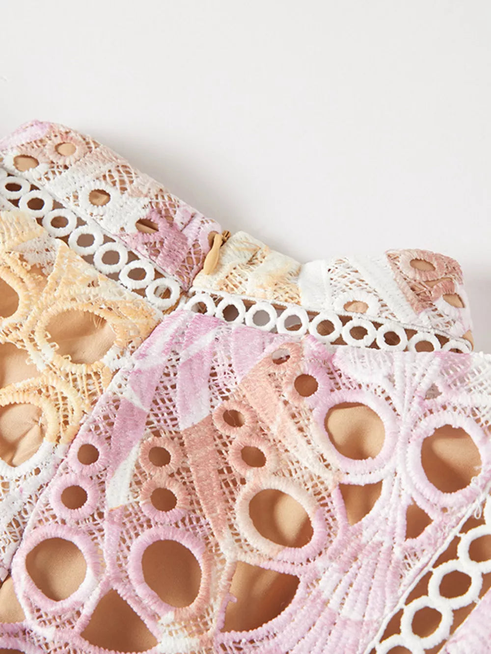 Luxe floral lace maxi gown in pink and purple with cutout details and a zipper closure.