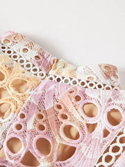 Luxe floral lace maxi gown in pink and purple with cutout details and a zipper closure.