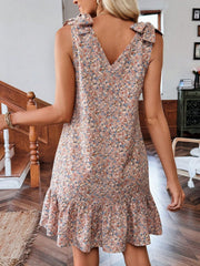 Floral tie strap mini dress in nude pink with ruffled hem and V-neck.