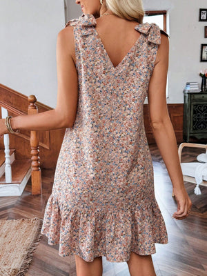 Floral tie strap mini dress in nude pink with ruffled hem and V-neck.