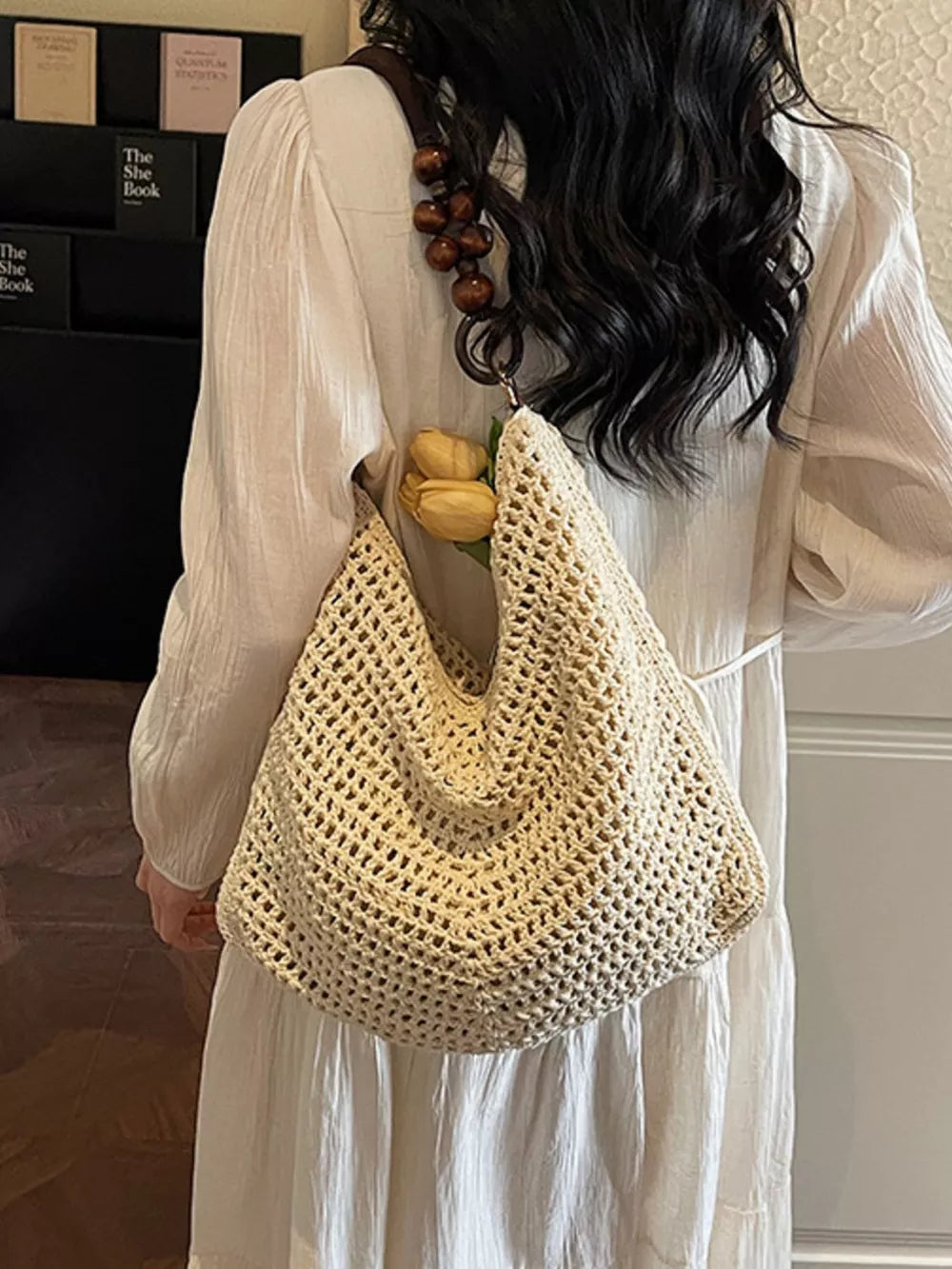 Textured knit shoulder bag in ivory with a wooden bead handle and a boho chic style.