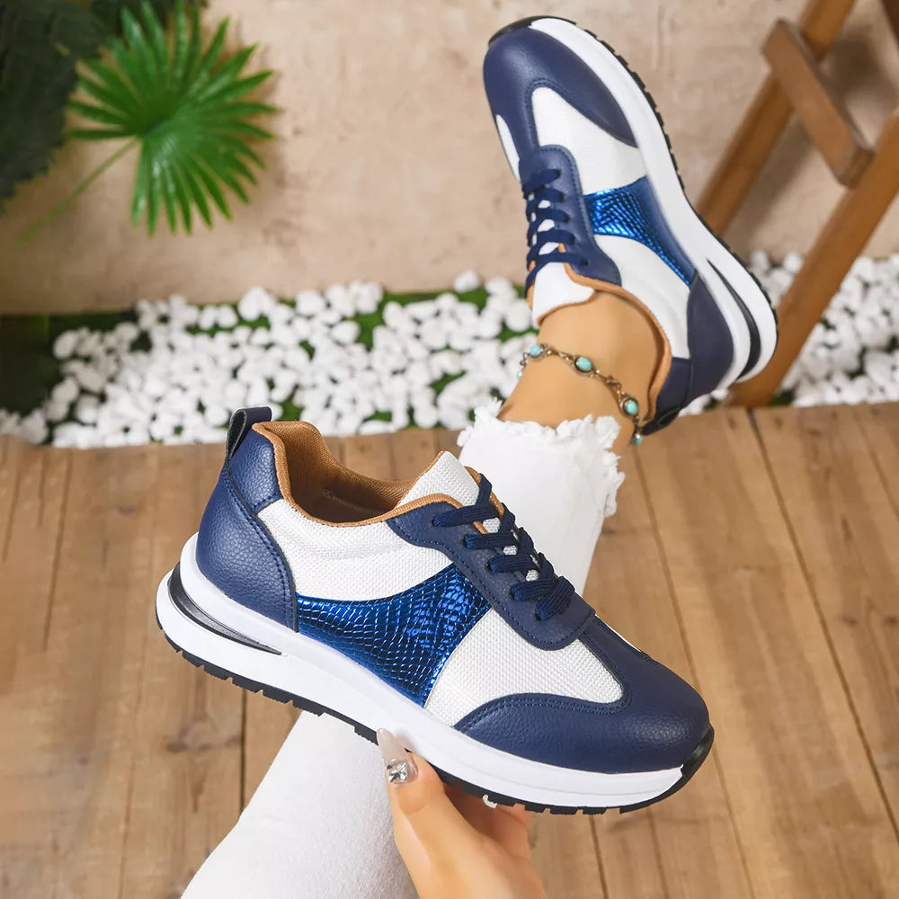 Blue and white lace-up sneakers with textured blue accents and white mesh panels.