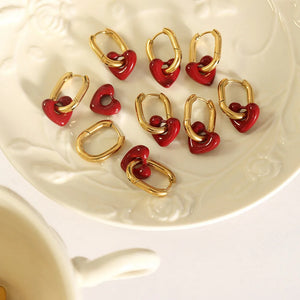Gold hoop earrings with red enamel heart charms