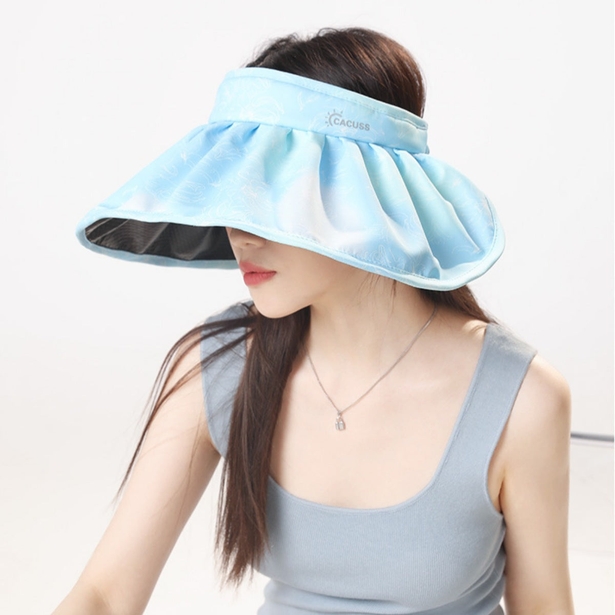 Blue pleated brim sun visor hat with a subtle pattern and wide brim.