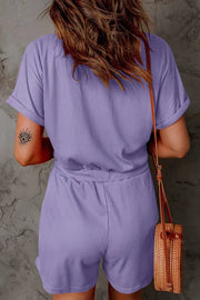 Lavender ribbed V-neck romper with cuffed sleeves and drawstring waist.