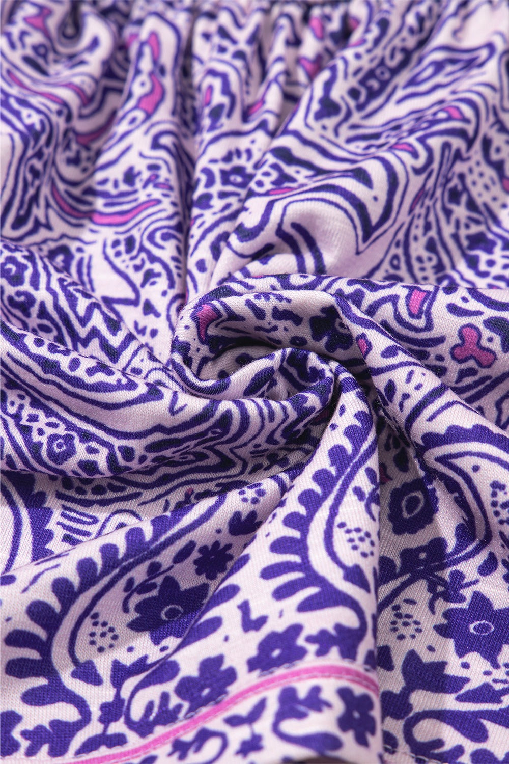 Paisley smocked bodice blouse in lavender with intricate purple and pink floral and paisley print.