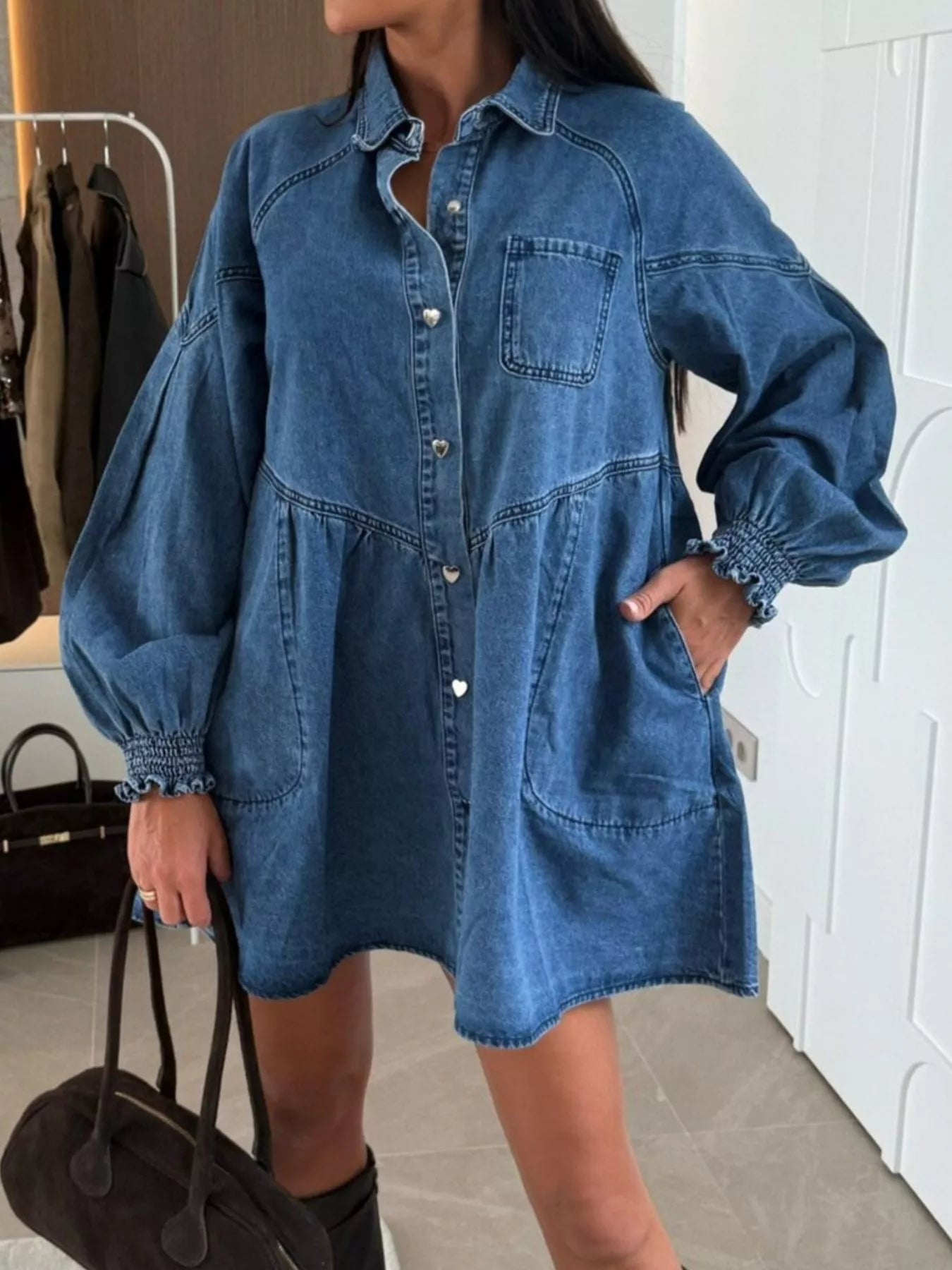 Buttoned blue denim mini dress with pockets, balloon sleeves and ruffled cuffs.