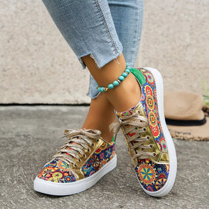 Mandala print round toe sneakers with gold laces and white soles.