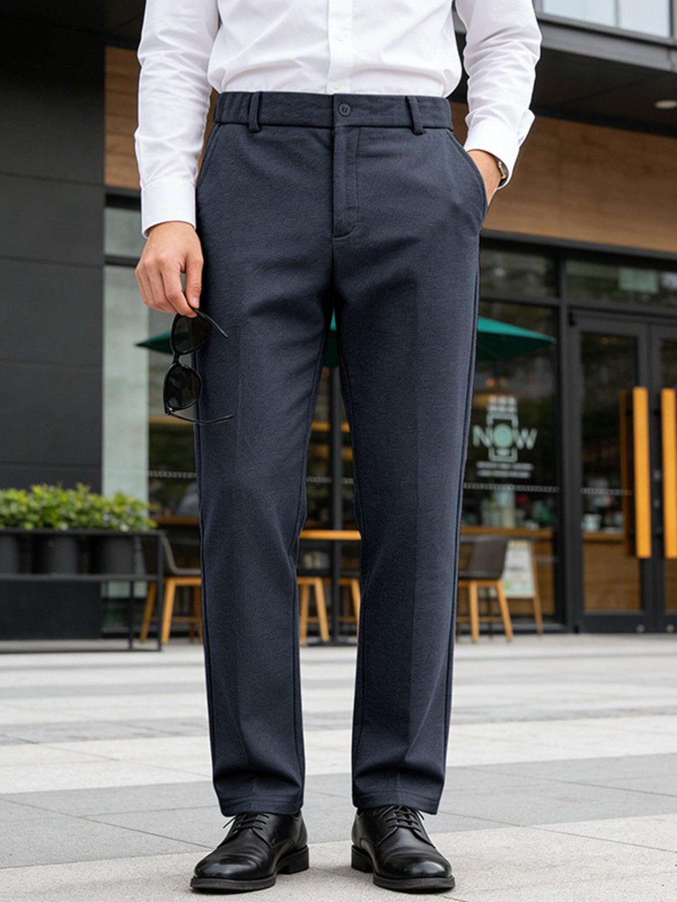 Classic fit navy dress pants with pockets, styled with a white dress shirt and black dress shoes.