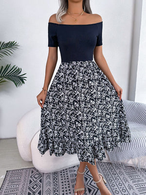 Black off-shoulder midi dress with short sleeves and a floral print A-line skirt.
