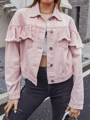 Blush pink denim trucker jacket with frayed ruffle details on the sleeves and chest.