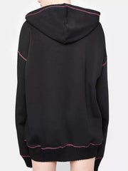 Black zip-up hoodie with playful pink contrast stitching and drawstring hood.