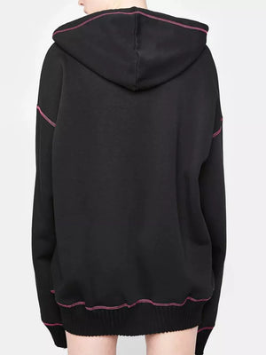 Black zip-up hoodie with playful pink contrast stitching and drawstring hood.