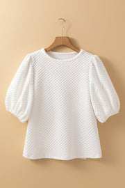 White textured quilted blouse with puff sleeves and round neckline