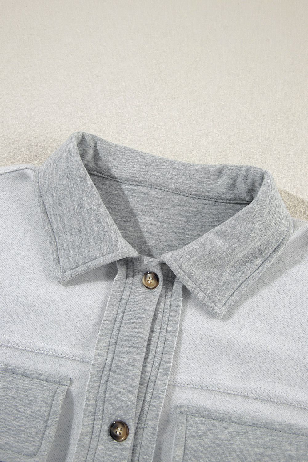 Light gray cotton utility vest with contrast trim and button-down front.