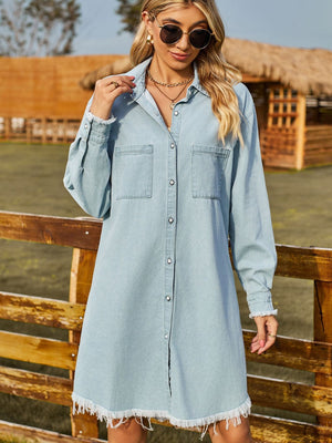 Light wash denim shirt dress with frayed hem and cuffs, button front, and chest pockets.