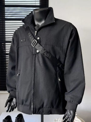 Black casual bomber jacket with zip front, buttoned pockets, and a crossbody strap.
