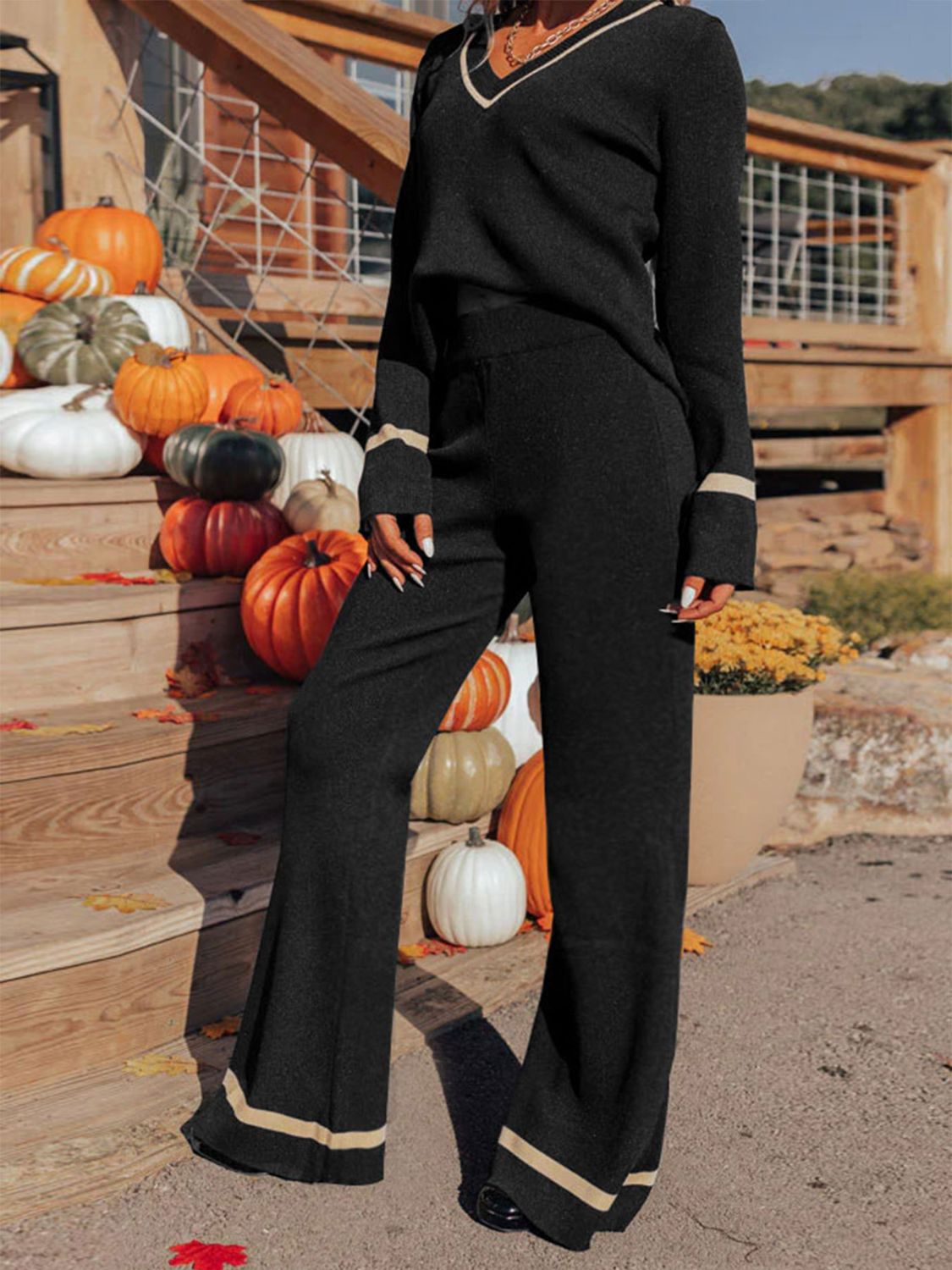 Black knit flare set with contrast trim on V-neck and cuffs, wide leg pants.