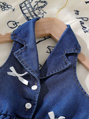 Dark blue denim sleeveless baby dress with white bowknot details and buttons.
