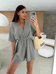 Dark gray twist-detail V-neck romper with dolman sleeves and cinched waist