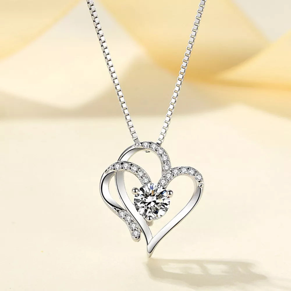 Elegant heart pendant necklace in sterling silver with cubic zirconia and delicate chain.