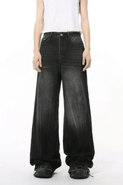 Dark wash wide leg jeans with a relaxed fit and faded details.