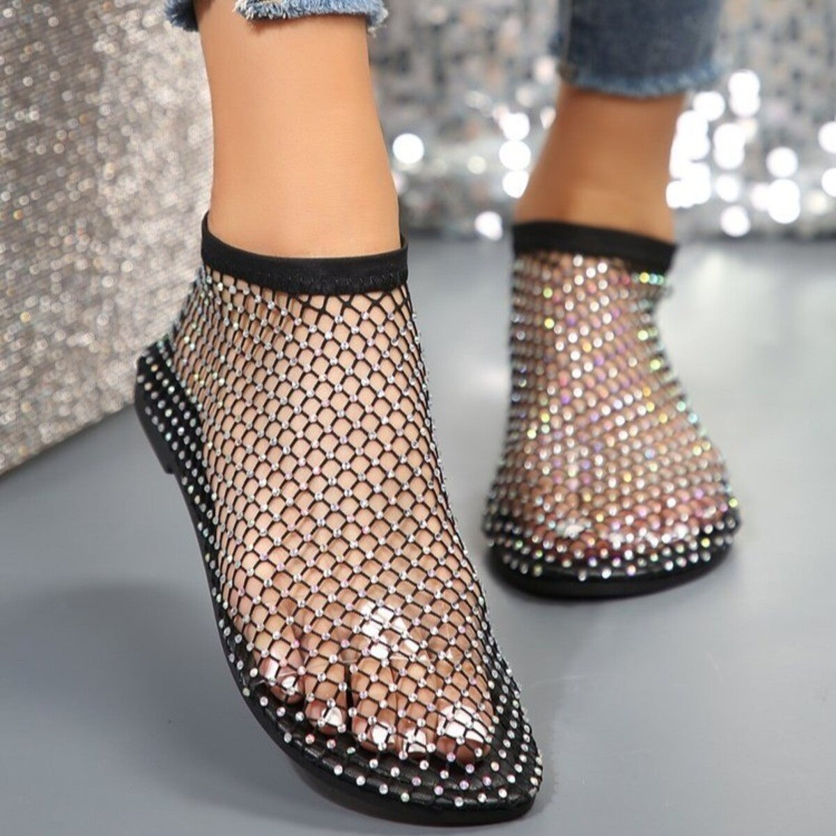 Black fishnet ankle boots with rhinestone embellishments and round toe