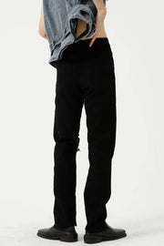 Black distressed knee modern straight leg jeans with a casual, chic style.