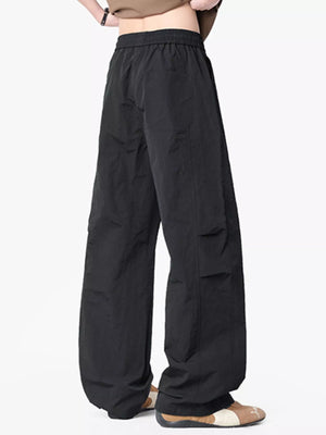 Black wide-leg drawstring pants with a relaxed fit and elastic waistband.