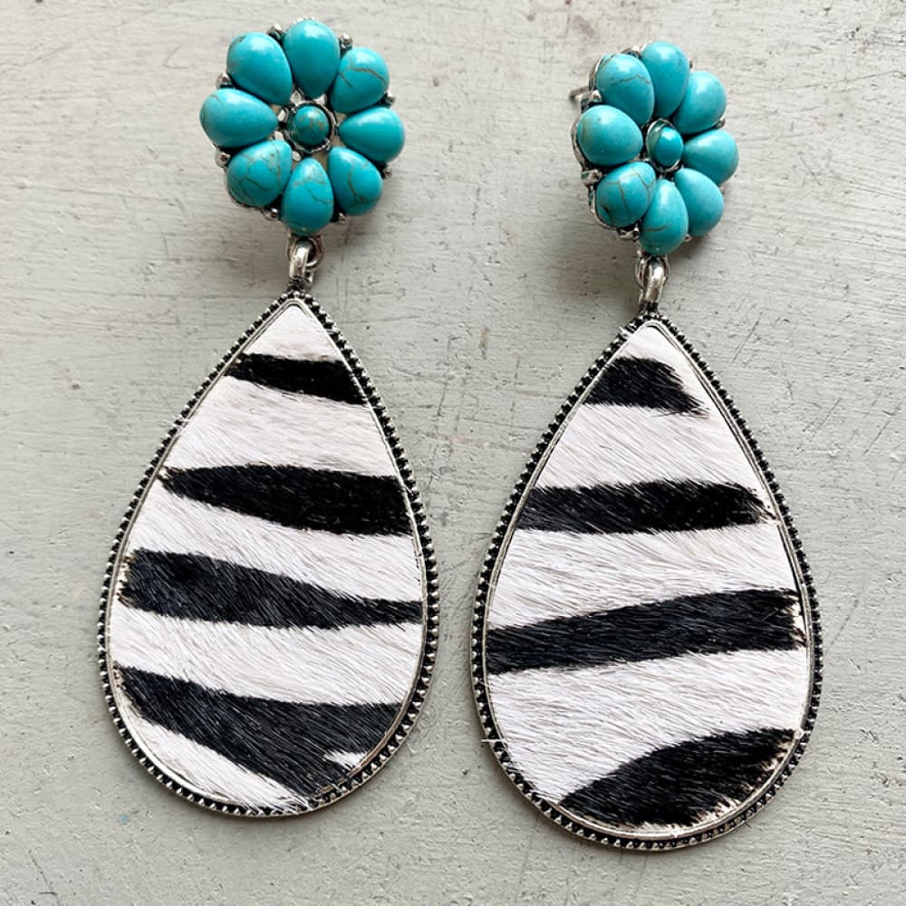 Turquoise petal top teardrop earrings with black and white zebra print hide.