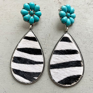Turquoise petal top teardrop earrings with black and white zebra print hide.