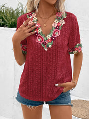 Burgundy peasant blouse with embroidered floral V-neck and eyelet fabric.