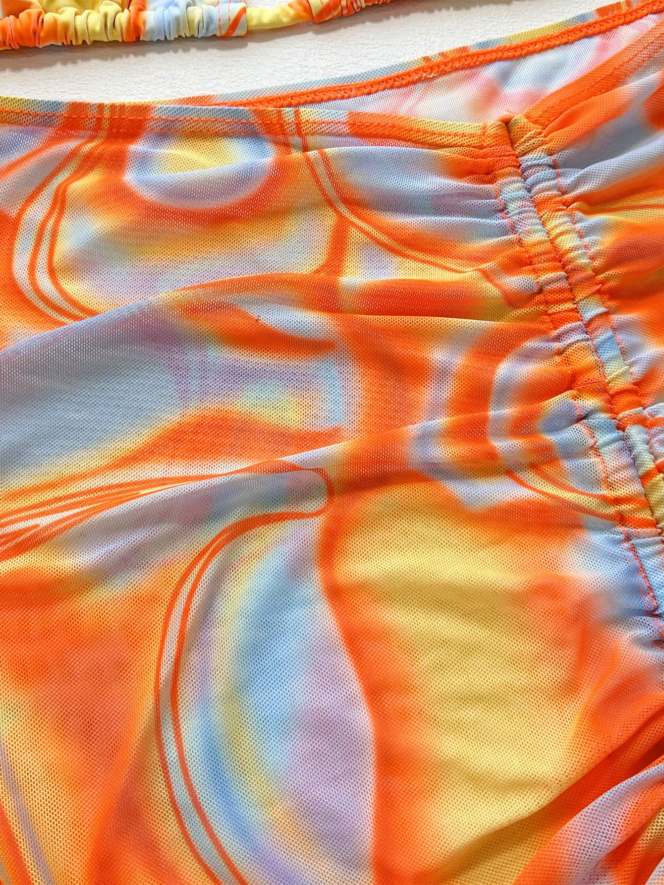 Multicolor swirl print string bikini set with ruched detailing.