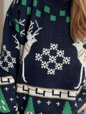 Navy acrylic knit sweater with white reindeer and festive geometric patterns.
