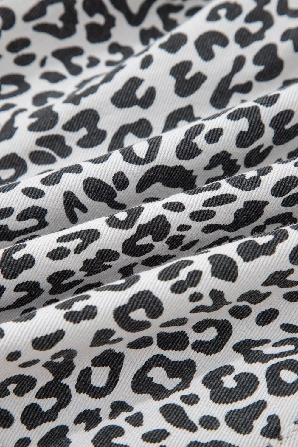 Leopard print denim skort with pockets in black and white cotton.