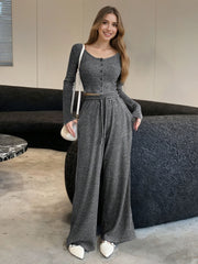 Gray ribbed knit two-piece set with button-down crop top and wide-leg pants.