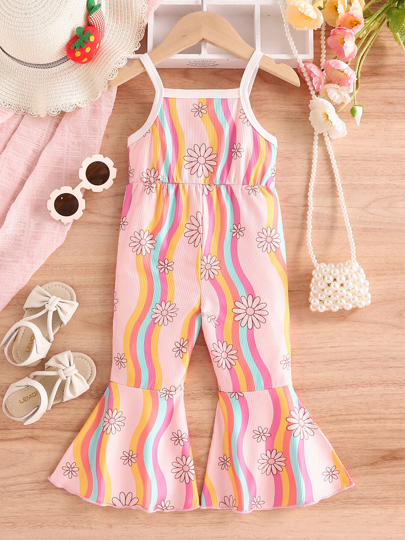 Baby floral print flared jumpsuit with rainbow stripes and spaghetti straps.