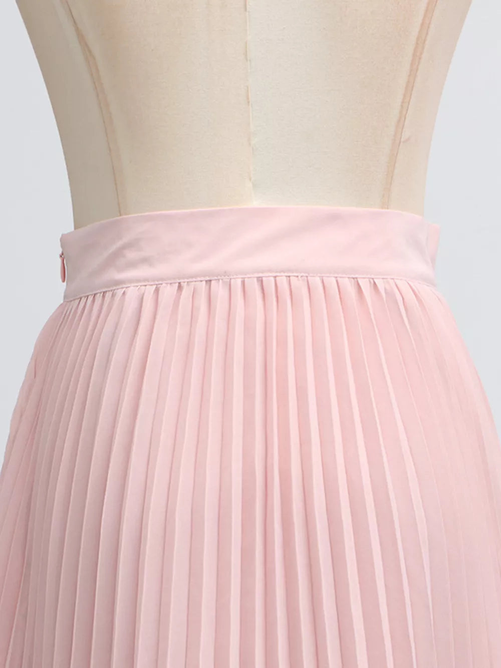 Pink pleated skirt with a side zipper detail and satin waistband.