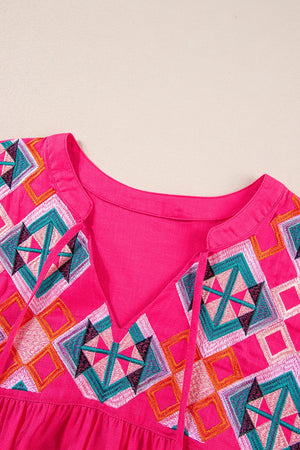 Strawberry embroidered yoke tie-neckline blouse with geometric pattern.