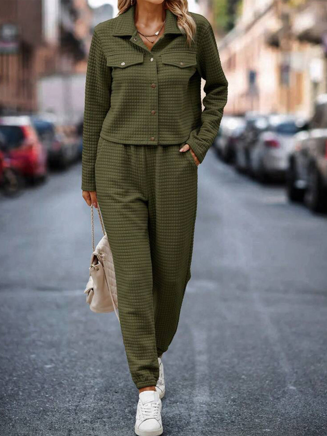 Army green quilted co-ord set with button-up jacket and joggers, styled with a cream bag.
