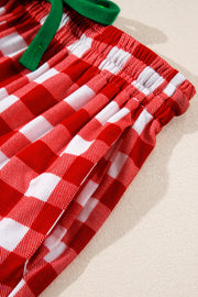 Festive red and white gingham pajama shorts with green drawstring and pockets.