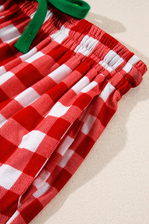 Festive red and white gingham pajama shorts with green drawstring and pockets.
