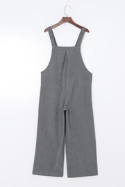 Corduroy overalls in dark gray with wide leg silhouette and buttoned straps.