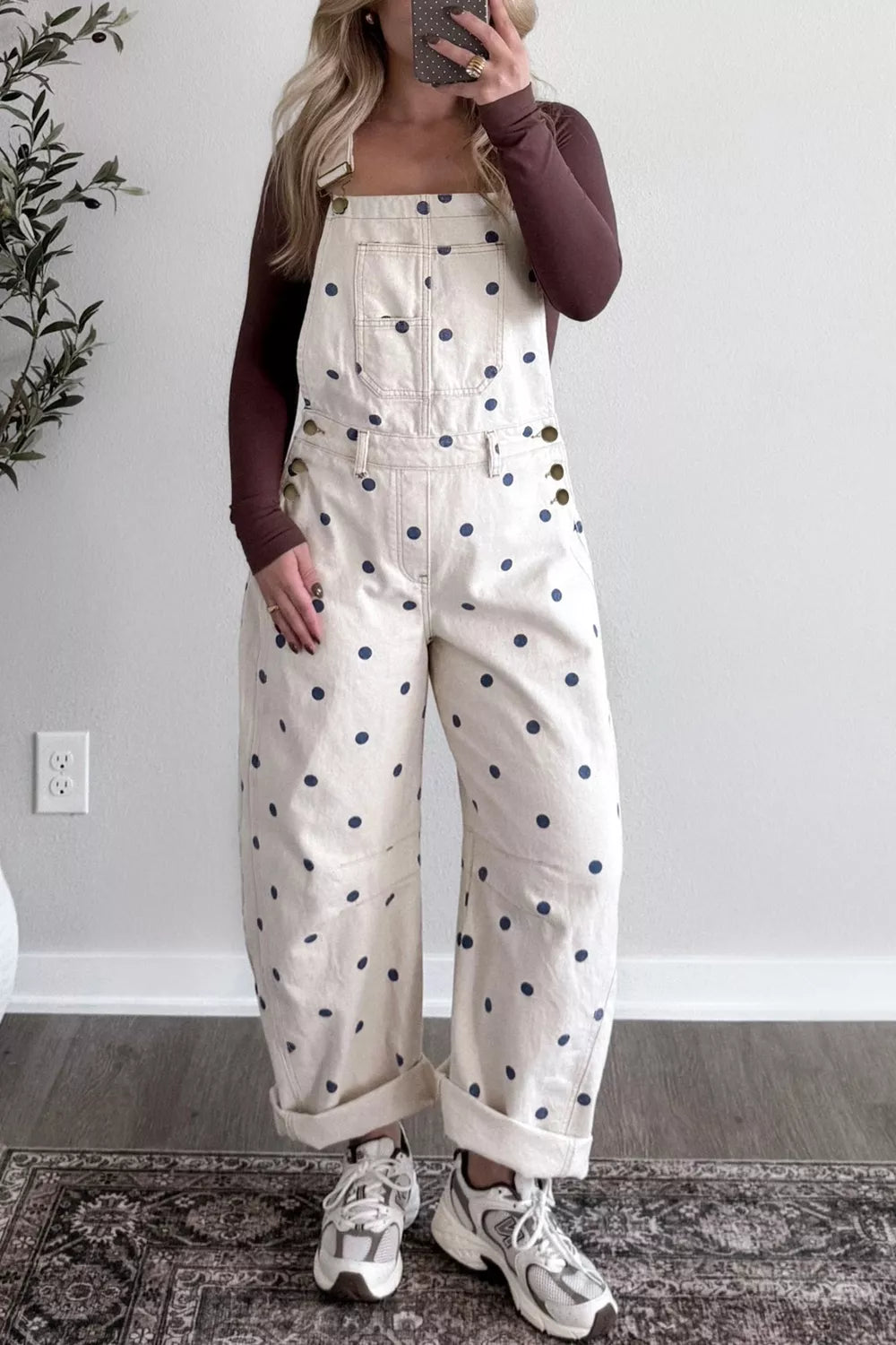 Denim overalls with navy polka dots, buttoned sides, and cuffed legs.
