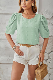 Light Green textured puff-sleeve blouse with pom-pom details and round neckline.