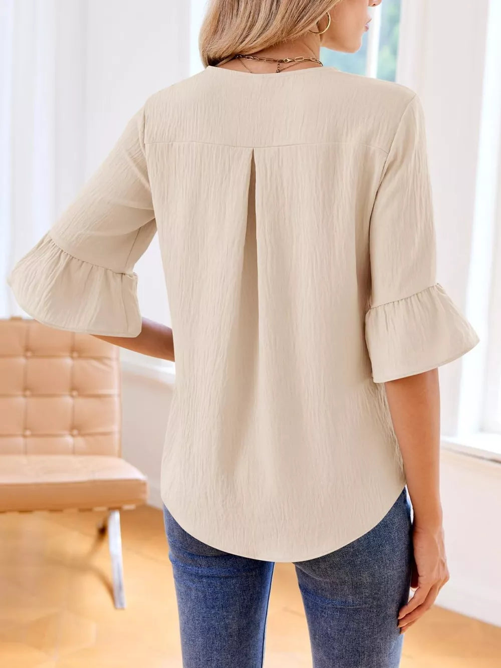 Apricot maternity shirt with 3/4 bell sleeves and cascading ruffles.