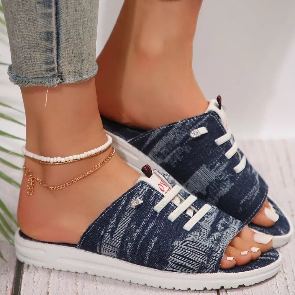 Distressed canvas open-toe platform sandals in dark blue with white laces and a white sole.