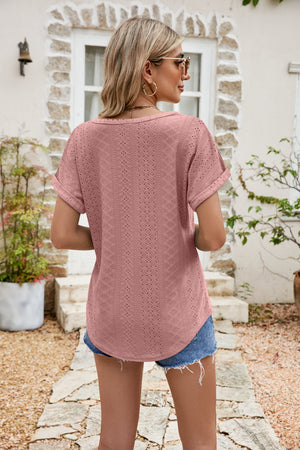 Blush pink perforated tee with rolled cuffs and a relaxed fit.