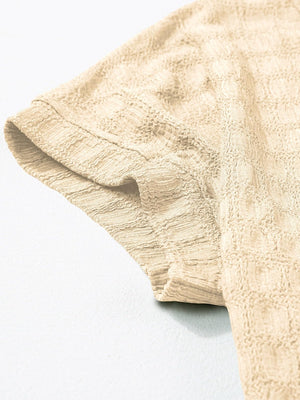 Tan woven texture cap-sleeve blouse with a textured grid pattern.