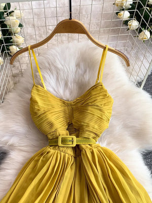 Yellow belted midi dress with spaghetti straps and pleated details